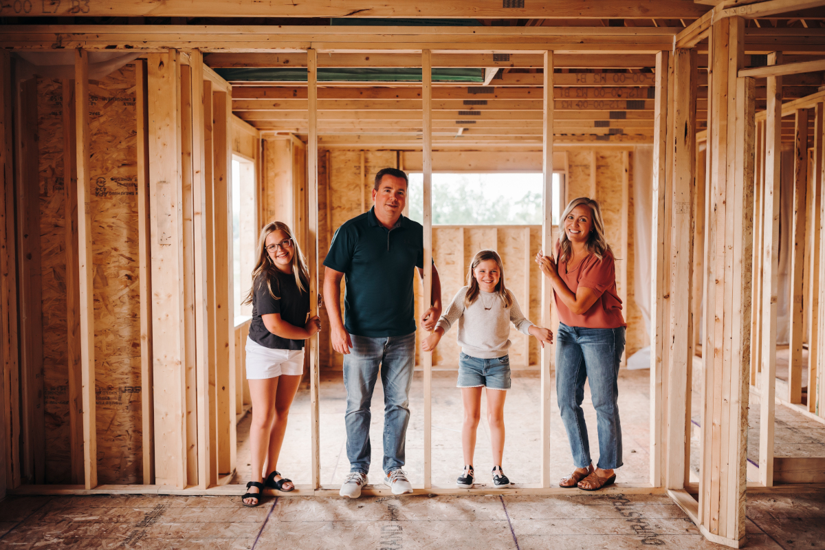 Parents and two children in home during framing stage